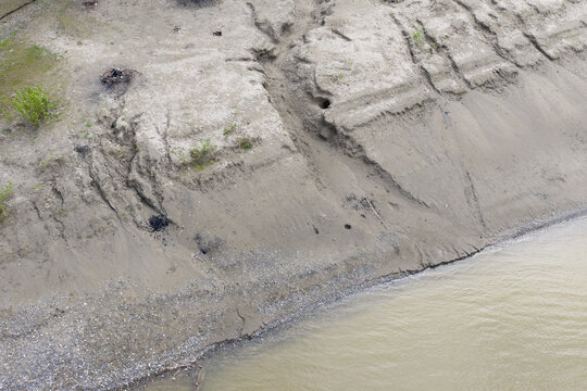 Aerial View Of Fraser River Shoreline Erosion And Muddy Bank With Sparse Vegetation