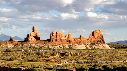 Turret Arch under sunset cloudy weather, with bushes in the foreground  © Yan