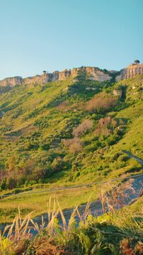 Gerace seen from below on a lateral hill at sunset