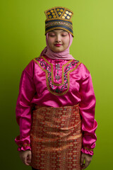 Naklejka premium Young Indonesian Asian Woman in Traditional Malay Costume and Hijab Wearing Ornate Headdress and Songket Skirt