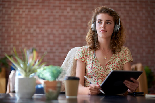 Headphones, tablet or woman thinking for remote work in cafe, streaming music or planning campaign. Podcast, tech or freelance marketer with idea for brand proposal, coffee shop or creative mindset