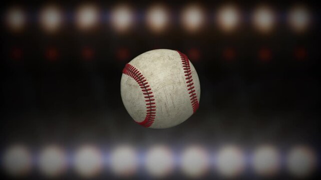 Worn baseball spinning toward camera with flashing stadium lights