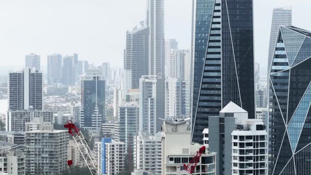 Tele close aerial panorama of Gold Coast high-rise towers on Pacific ocean waterfront in Australia.