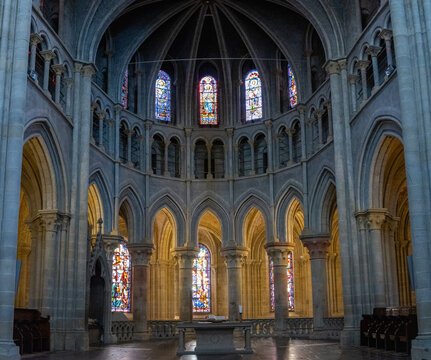 Altar and stained glass in Gothic cathedral interior, Lausanne