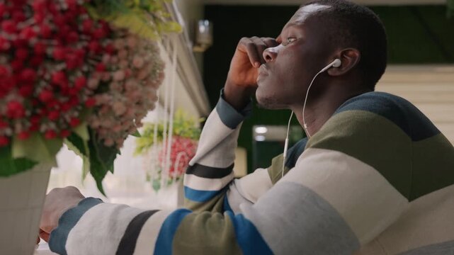 Smiling man expresses happiness on romantic call. He laughs softly as affectionate dialogue flows smoothly. Cheerful gentleman enjoys intimate phone chat with bright expressive emotions
