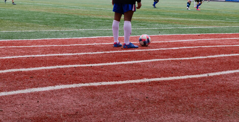 Obraz premium Soccer player with ball on running track, football training and sports concept