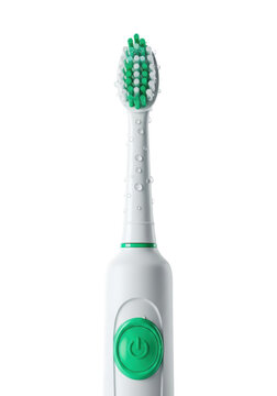 White matte electric toothbrush with mint green accents and glistening water droplets on layered bristles in a bright white studio concept of dental health