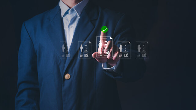 Businessman pointing at virtual candidate profiles for recruitment and hiring, Concept of talent acquisition, executive search, human resources management, and selecting the best qualified employee.