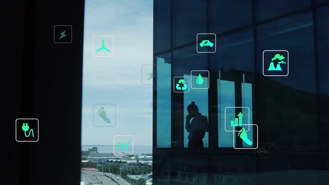 Man bringing phone to ear by glass, monitoring energy data, icons clustering around reflection