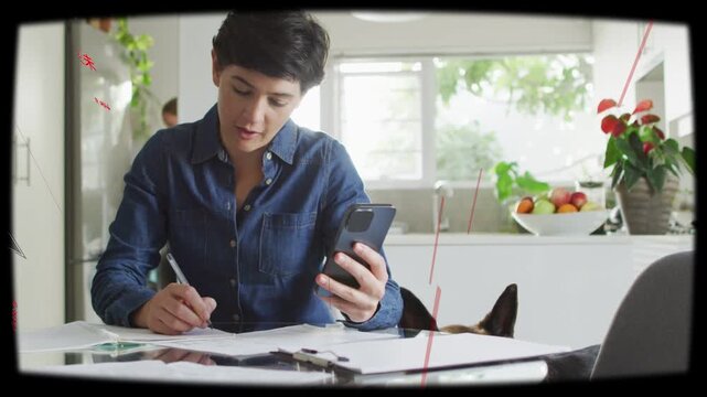 Woman kitchen table paying bills writing, checking phone causing overlays rising, dog ears peeking