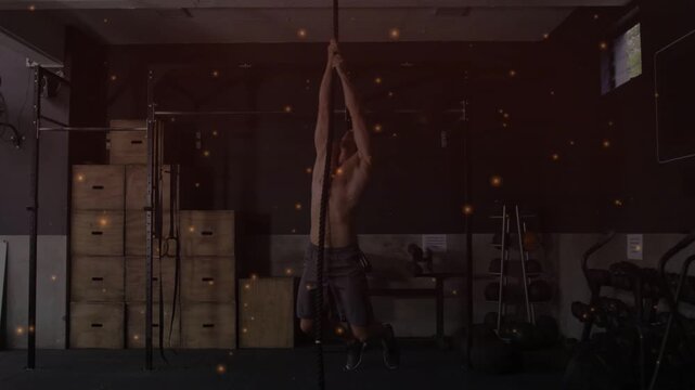 Man gripping rope, climbing and lowering with leg tucks for fitness, particles highlighting motion