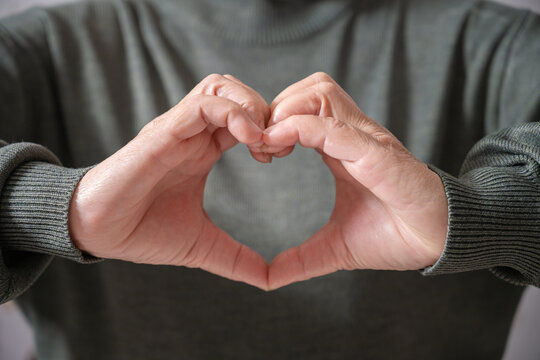 Close up Woman hands maling heart shape sign ,word heart day, insurance,social responsibility, donation, organ donor