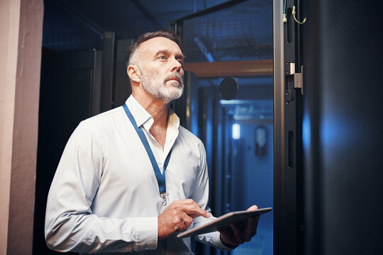 Tablet, man and rack inspection in server room for cybersecurity, hardware maintenance or solution. IT technician, mature person or tech in data center for system backup, troubleshoot or diagnostics