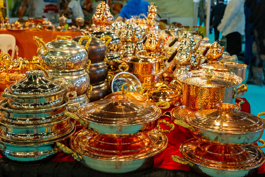 Metal coffee cezve with decorative oriental pattern on the shop window. Household items copper items for sale. Cupric coffeepots at the bazaar in Antalya Turkey. Turkish coffee pots. Metal coffee cezv