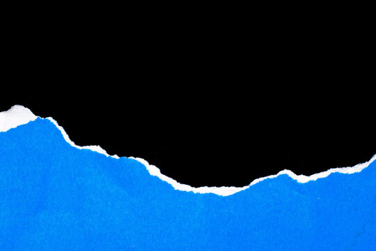 Torn paper reveals a stark black void against vivid blue. Edges fray unevenly, creating raw, textured contrast. Background hue shines bright, evoking boldness and depth. Perfect for design, editorial