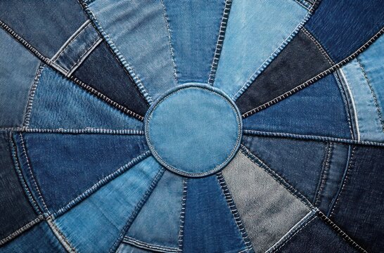 circular denim patchwork made from stitched jeans panels in varying shades of blue with radial seams and a central round patch conveying handcrafted, cozy rustic charm