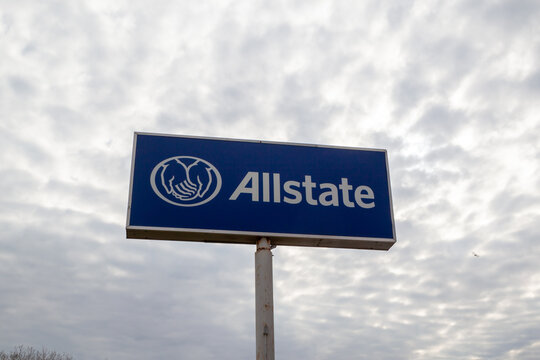 Chicago, Illinois, USA - March 29, 2022: Allstate Insurance company logo on a blue pole sign against a cloudy sky. Chicago, Illinois, USA. 
