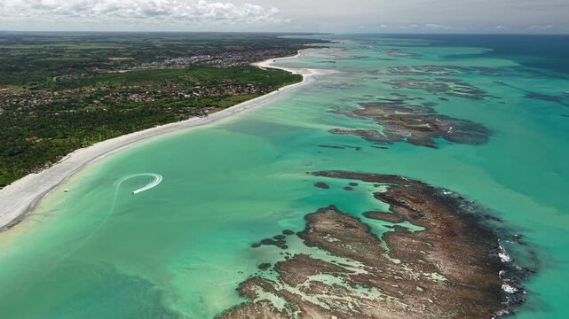 Drone view of the reefs during low tide at Ipioca Beach, Macei&oacute;, reveals natural patterns in the sea and shallow crystal-clear waters - Alagoas, Brazil