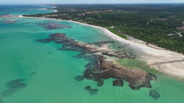 Drone view of the reefs during low tide at Ipioca Beach, Macei&oacute;, reveals natural patterns in the sea and shallow crystal-clear waters - Alagoas, Brazil