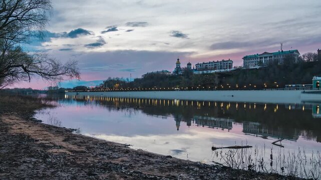 sunset over the embankment on the Ural River in Orenburg, time-lapse - the sun sets behind the horizon