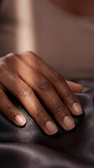 Fototapeta premium Macro hand on silk fabric in soft light