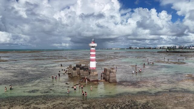 At low tide, the Ponta Verde Lighthouse reveals a unique landscape, surrounded by reefs and shallow waters that allow visitors to walk out into the sea in Macei&oacute;.- Alagoas, Brazil