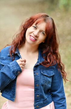 Retrato de una mujer joven guatemalteca, con cabello casta&ntilde;o, chaqueta azul y blusa rosada, estilo de vida al aire libre.