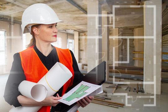 Construction, Building renovation. Female engineer reviews floor plans and inspects interior site with laptop, helmet and project documents