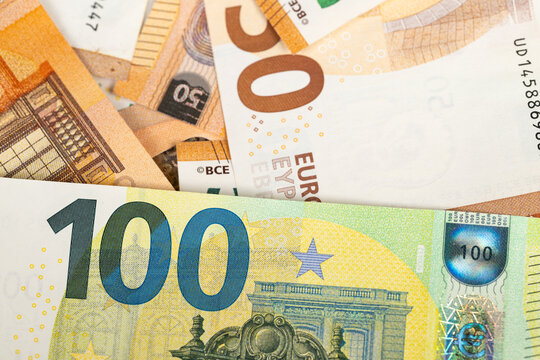 Closeup of euro banknotes with note foreground, contrast between green and orange notes creates highvalue narrative for investment, savings or premium finance contexts