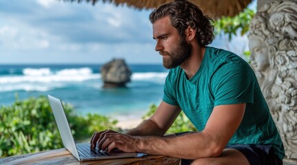 Obraz premium Bearded man focused on his laptop, working outdoors with stunning ocean view and lush greenery. High quality photo
