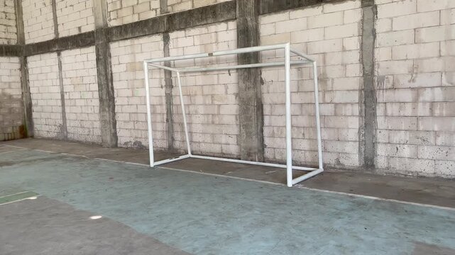 White Metal Futsal Goal Frame in Industrial Interior