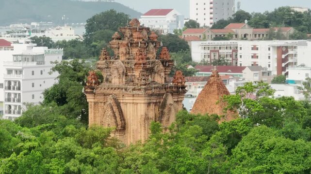 The Po Nagar Cham Towers, a historic Hindu temple complex, stand amidst lush greenery in Nha Trang, Vietnam. These ancient structures offer a glimpse into Vietnam's rich cultural heritage.