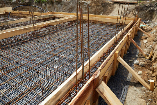 Reinforced concrete foundation with steel rebar grid and wooden formwork