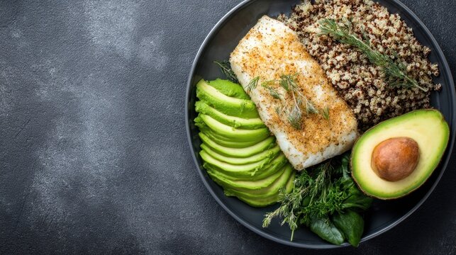 A plate of fish, avocado, and quinoa, garnished with herbs and spices, set against a dark, textured background.