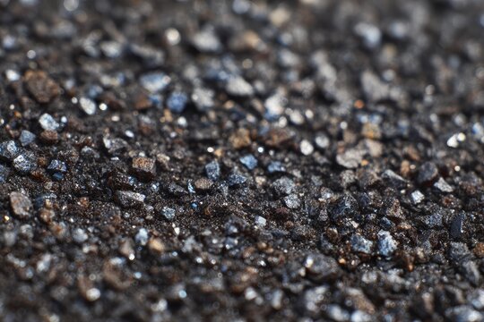 Close-up macro view of coarse dark grit with sparkling highlights