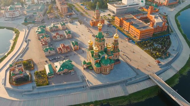 Yoshkar-Ola, Russia. Cathedral of the Annunciation of the Blessed Virgin Mary, five golden onion domes rising above a Russian-style cross-in-square structure, Drone footage at sunset. Drone footage, 