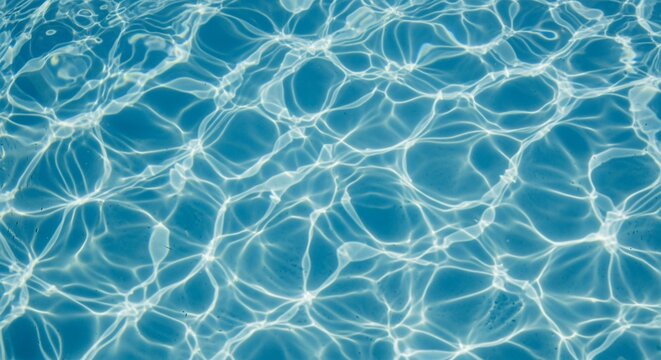 Blue swimming pool water ripples with bright sun caustics and light reflecting on clear surface