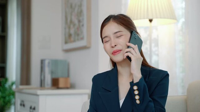 Young professional asian businesswoman using smartphone for work communication, representing remote work, entrepreneurship, and modern business lifestyle.
