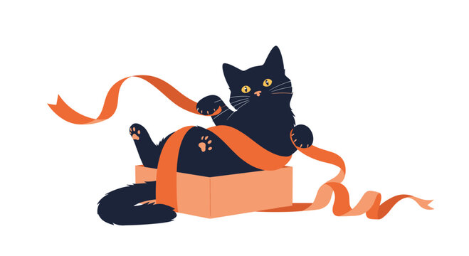 Cute black kitten playing with a long orange ribbon while sitting inside a small cardboard box on a plain white background.
