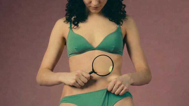 A freaky neat woman looking at lower part cleanliness with magnifying mirror hygiene awareness and bodily car