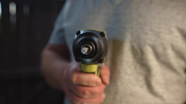 Close up rotating drill bit in cordless screwdriver held by man demonstrates power tool operation stable rotation and precision for installation and repair tasks
