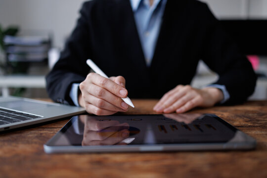 Business professional hand drawing on digital tablet with stylus