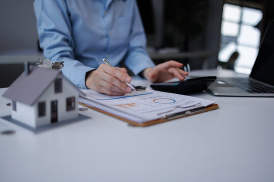 Person calculating real estate mortgage finance tax investment planning