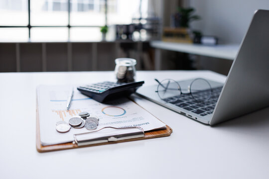 Financial adviser reviewing budget and accounting reports on table