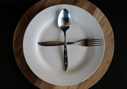 The position of the spoon and fork crossed on the plate as seen in the picture is generally used in table manners to indicate that you are ready for the next course.