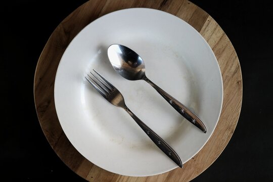 The position of the spoon and fork in the image you sent, with both cutlery placed vertically or tilted at about 45 degrees, in table manners, this position gives a non-verbal signal to the waiter.