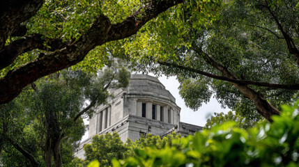 Fototapeta premium A large white building with a dome roof surrounded by green trees and bushes