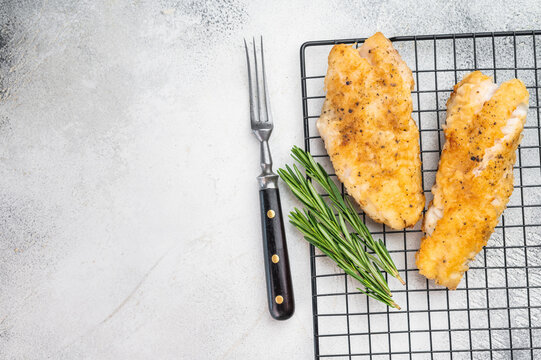 Cooked red snapper fish fillets in pan with citrus and herbs. Fresh seafood meal.