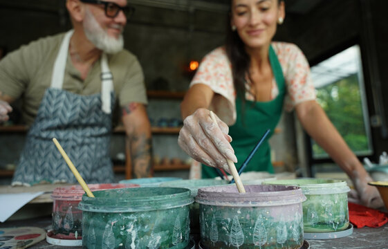 A happy couple makes ceramic plates in a workshop