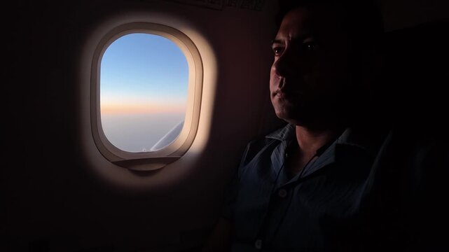 A passenger gazes thoughtfully out a commercial airplane window during high‑altitude flight, matching your earlier serene sunrise/sunset aviation scene.